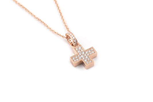 Gold chain with a cross, one side set with diamonds and the other with rubies.