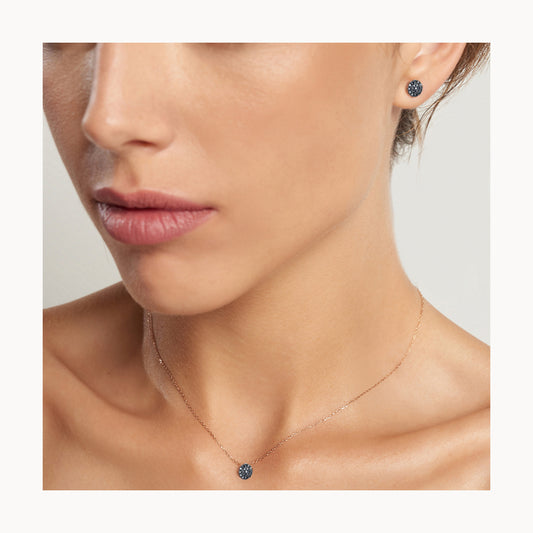 Earrings in rose gold with a circle of black diamonds.