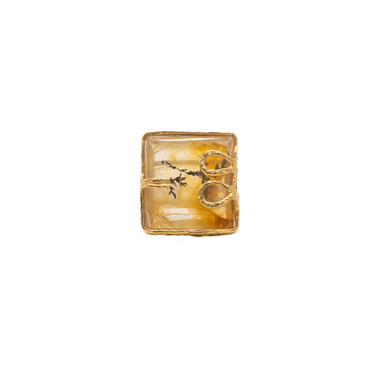 Gold ring with a square tooth stone.